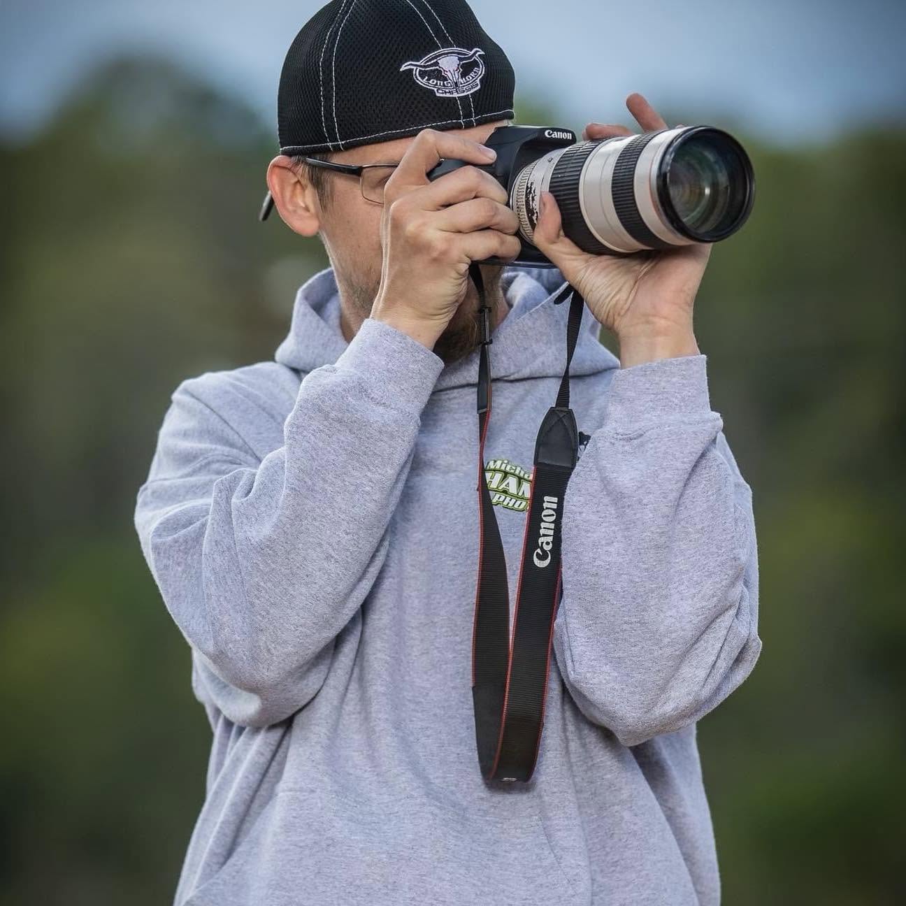 Michael Hamilton photographing an event with his camera