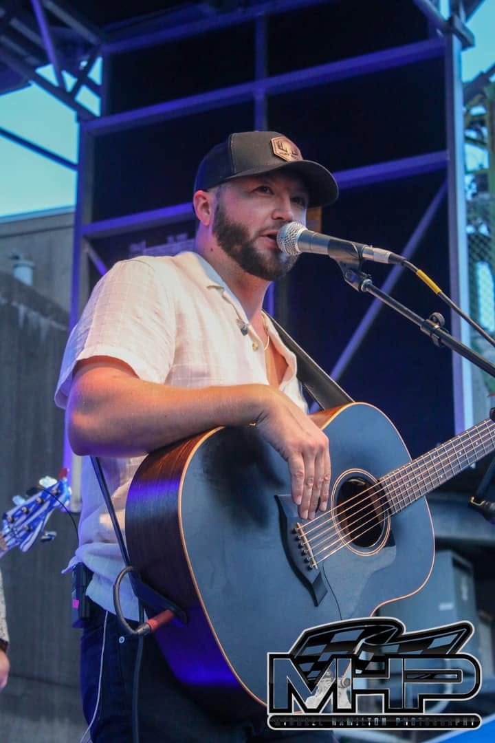 Kelsey Hart performing with a guitar